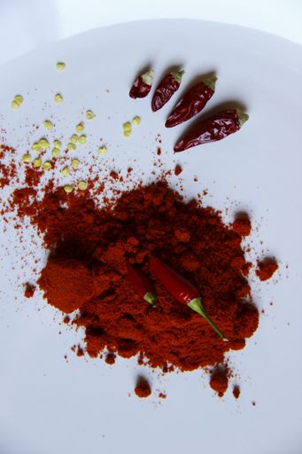 A top view of chili pepper and paprika with white background.