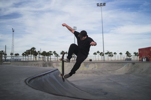 A beautiful shot of a man skateboarding in a skatepark during daytime