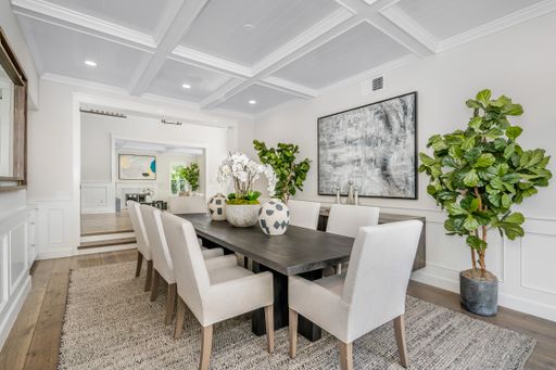 A luxurious home with an elegant dining table with plush chairs