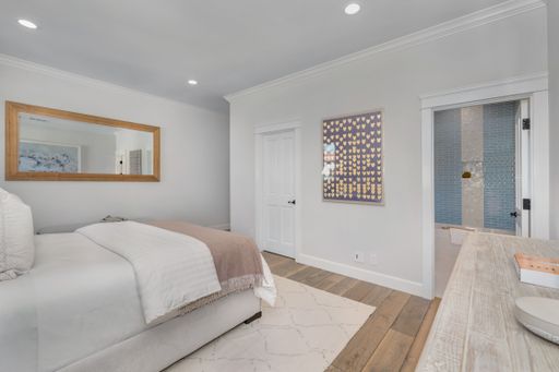 A clean contemporary bedroom with ensuite bathroom