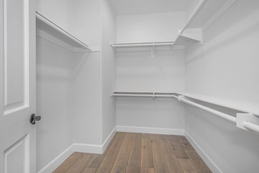 A spacious white pantry with empty shelves
