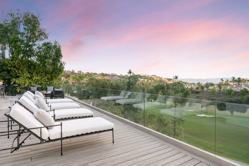 A spacious balcony with a stunning landscape and tree views