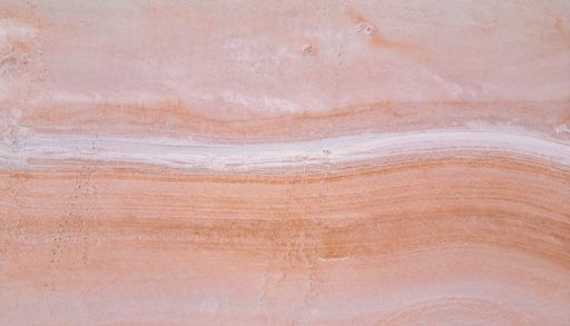 A pink granite with red veins in a quarry floor
