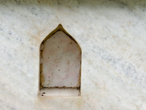 A closeup of a small hole on a marble background