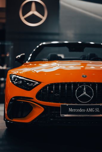 A vertical shot of the front side of the luxury Mercedes-Benz AMG SL against blur background