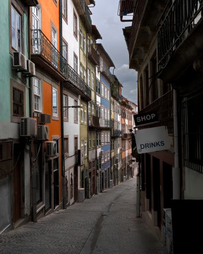The colorful buildings creates a charming alley. Oporto