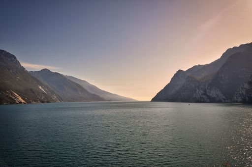 landscape photo of the beautiful evening view from Monte Brione, Riva del Garda, to the south lake,mountains, dramatic sky, sunset