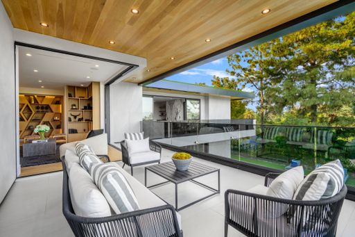 A scenic view of an outdoor patio surrounded by trees.