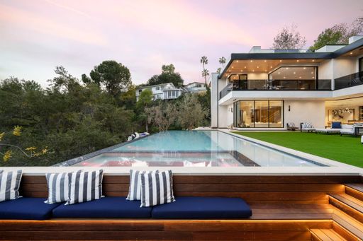 A scenic view of an outdoor patio surrounded by trees.