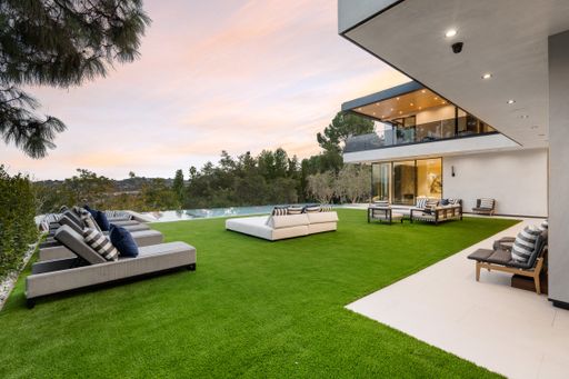 A scenic view of an outdoor patio surrounded by trees.