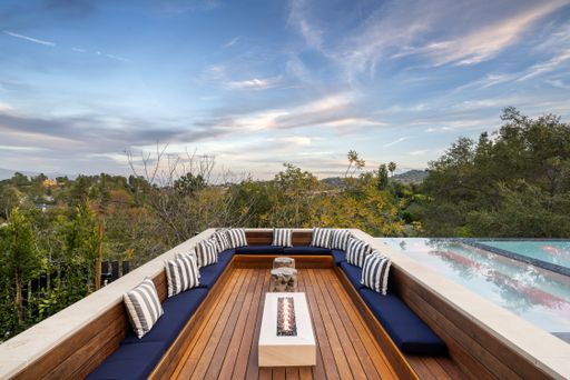 A scenic view of an outdoor patio surrounded by trees.