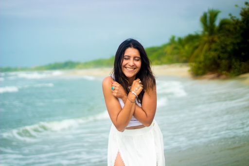 A young Hispanic female smiling and having fun on the beach