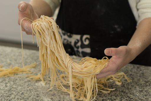 A closeup shot of a chef making a  homemade pasta in his kitchen
