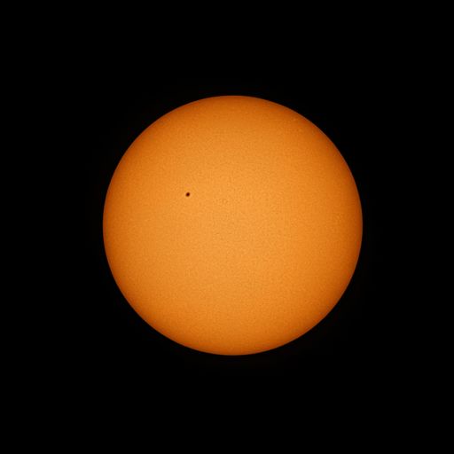 A view through a telescope of the sun with a sunspot