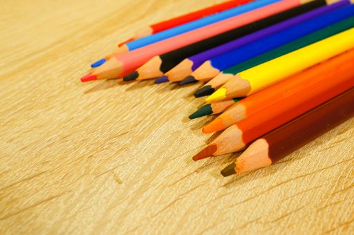 A closeup shot of colored pencils near each other on a wooden surface