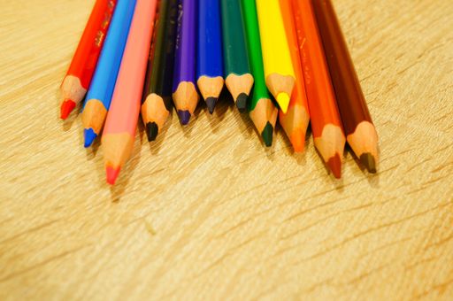 A closeup shot of colored pencils near each other on a wooden surface