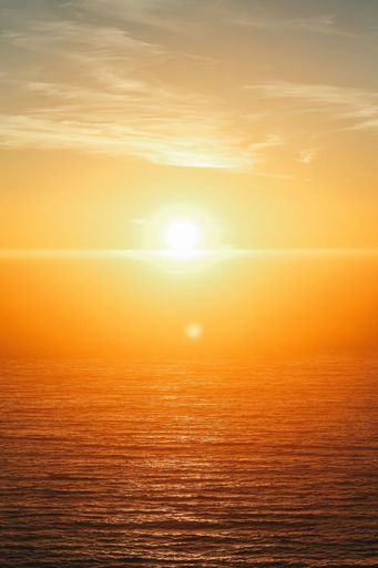 A vertical shot of a beautiful sea at sunset at Big Sur, California, USA