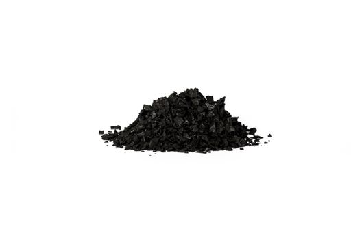 A closeup of a pile of activated carbon crystals isolated on a white background