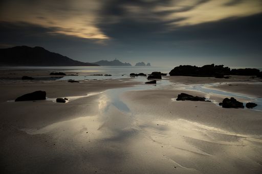 A beach with hills in the background on a cloudy day near Cabo Vilan in Galicia, Spain