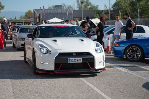 Front view of a white Nissan GT-R35 at a Japanese sports car meet.