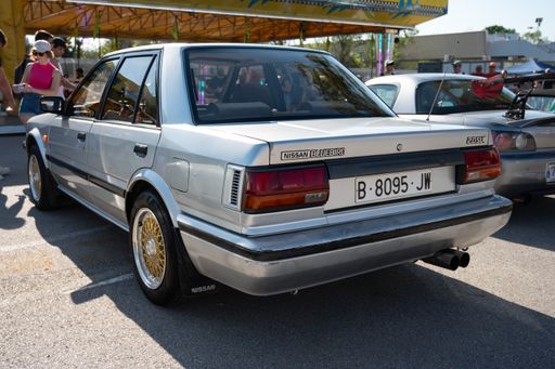Rear view of a classic Japanese sports car Nissan Bluebird 2.0SLX of the T12 T72 Series generation in silver gray color