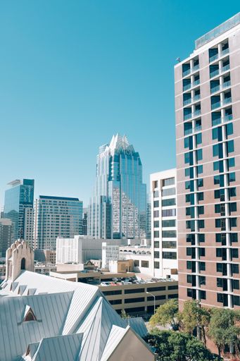 A vertical shot buildings in Downtown Austin and a tall glass building in Texas, USA