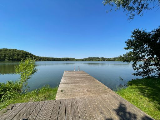 A wooden platform over the lake with beautiful scenery ahead