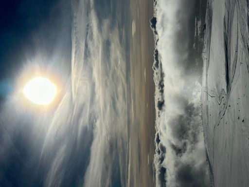 The Sun over sky on a winter mountain