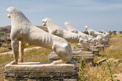 A sunny day in Delos, Greece with white statues