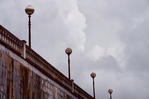 A low angle shot of street lamps on a bridge