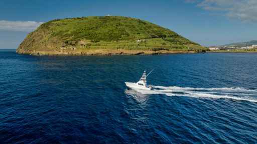 Sport Fishing Boat in the Azores, Portugal  North Atlantic Ocean with mountains, blue water, and greenery in the background