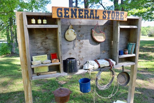 A wooden shelf holding various items on display