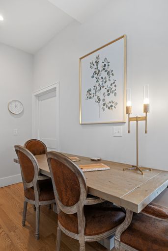 A table and chairs with one chair on each side of the table