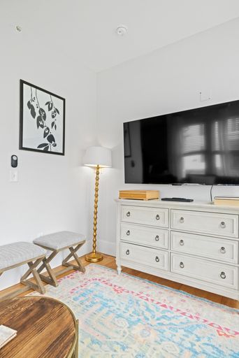 Living room interior with modern furniture and flat screen TV on wall