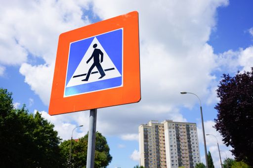 A low angle shot of a pedestrian crossing sign