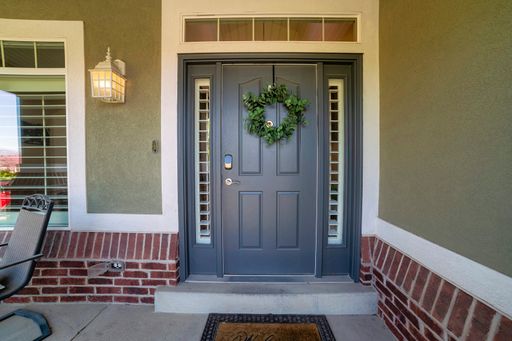 A closeup shot of a blue front door decorated with a holiday wreath