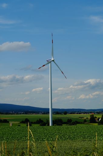 A Mainova wind turbine against the blue sky with clouds. Mainova is a leading local energy supplier and buys up existing plants in the region.