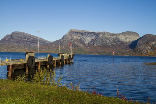 A beautiful scenery of a lake and fjords in Norway under a blue clear sky