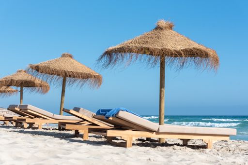 The deck chairs and straw umbrellas on the wonderful island of Formentera in Spain
