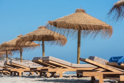 The deck chairs and straw umbrellas on the wonderful island of Formentera in Spain
