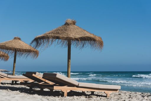 The deck chairs and straw umbrellas on the wonderful island of Formentera in Spain