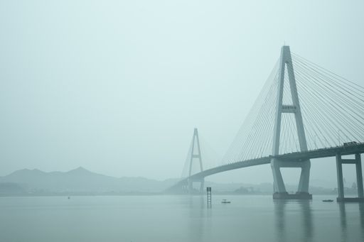 A scenic view of Queshi Bridge on a misty day