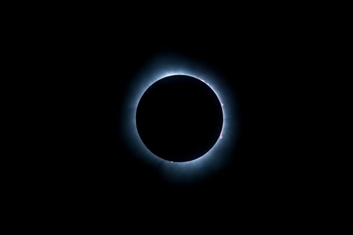 A solar eclipse featuring a diamond ring effect and baileys beads