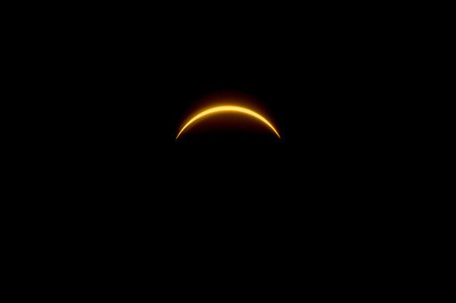 A solar eclipse featuring a diamond ring effect and baileys beads