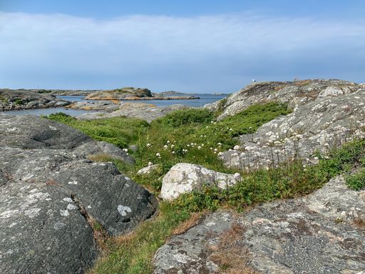 View of the archipelago in northern Gothenburg. Nature photography, blue sky and sea, cliffs in the foreground. A nice summer day in Sweden.