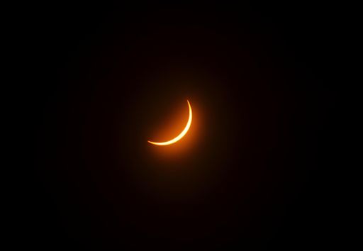 A captivating view of a solar eclipse with a ringed moon in the sky