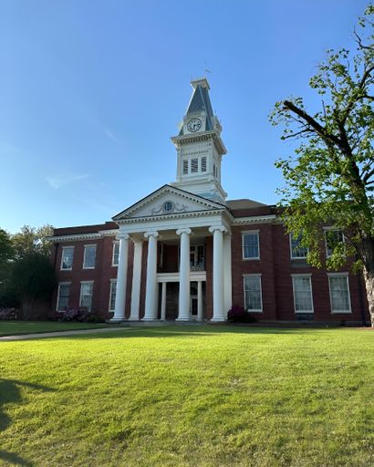The historic Baldwin County Courthouse under a clear blue sky on a sunny day