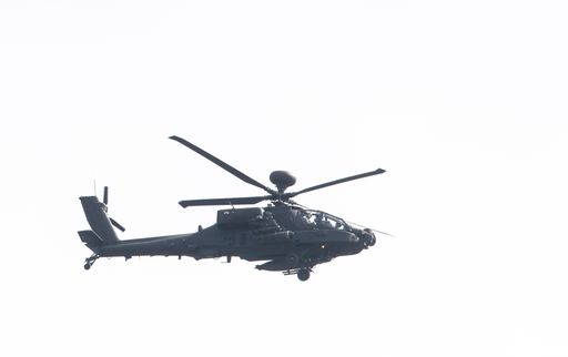 A military helicopter in flight demonstration against clear sky