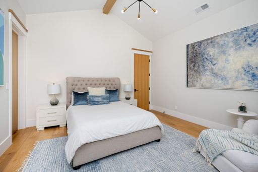 Bedroom with spacious bed and central desk area