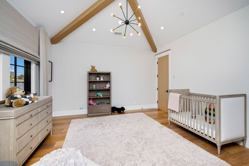 Baby's room with wooden beams and white walls